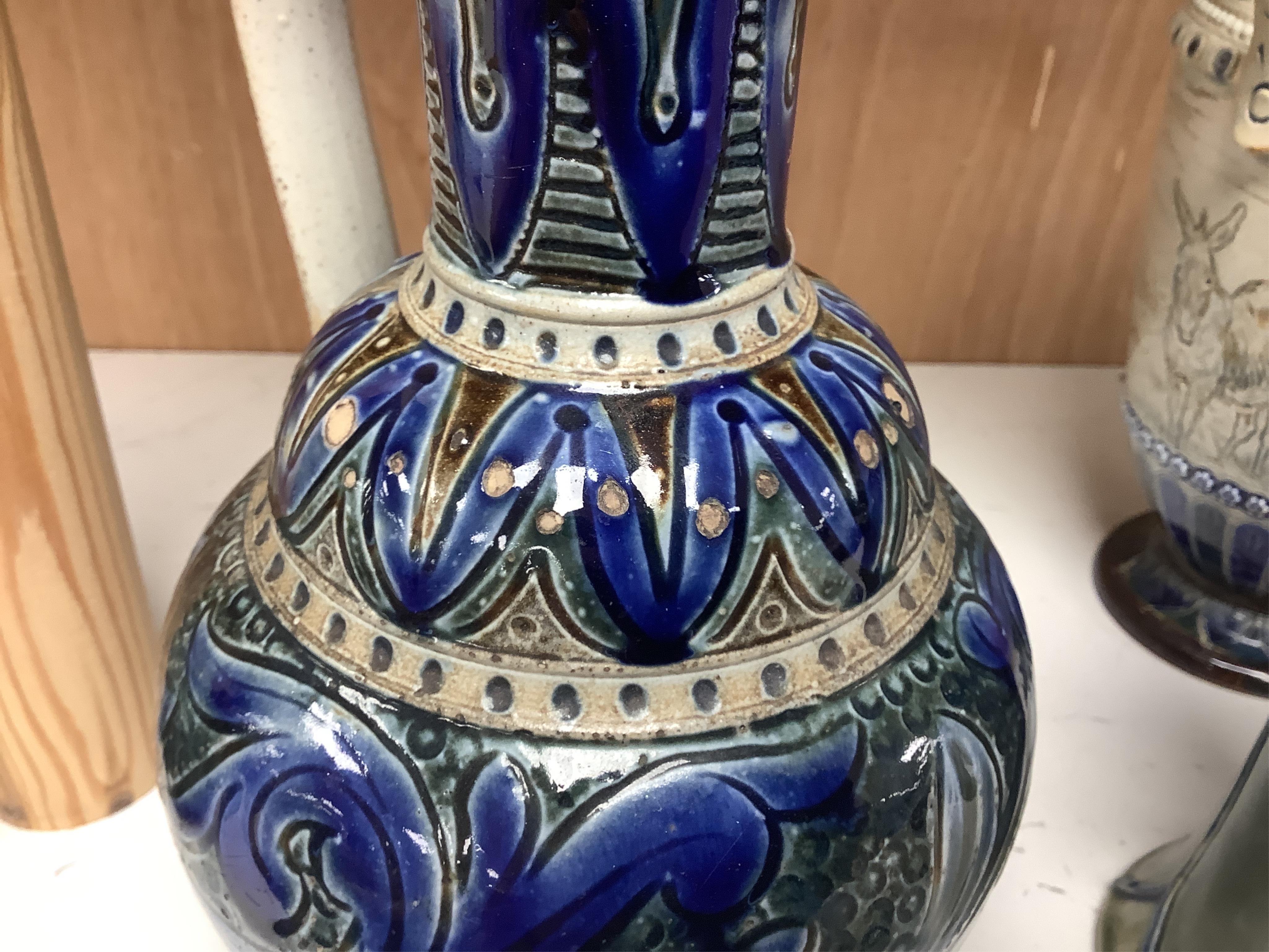 A Hannah Barlow for Doulton ‘geese and donkey’ jug, another jug dated 1874 and a small Royal Doulton vase, largest 24cm high. Condition - good